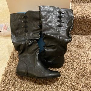 New in box black faux leather knee high boots with zip up side with details.